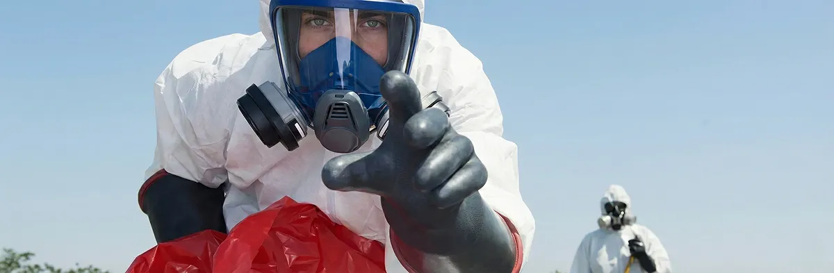sewage clean up technician wearing protective gear handling biohazard materials in Fort Wayne, IN